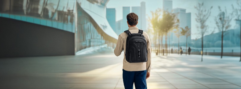 Ein Mann läuft zum Bahnhof mit einem Wenger Rucksack. 