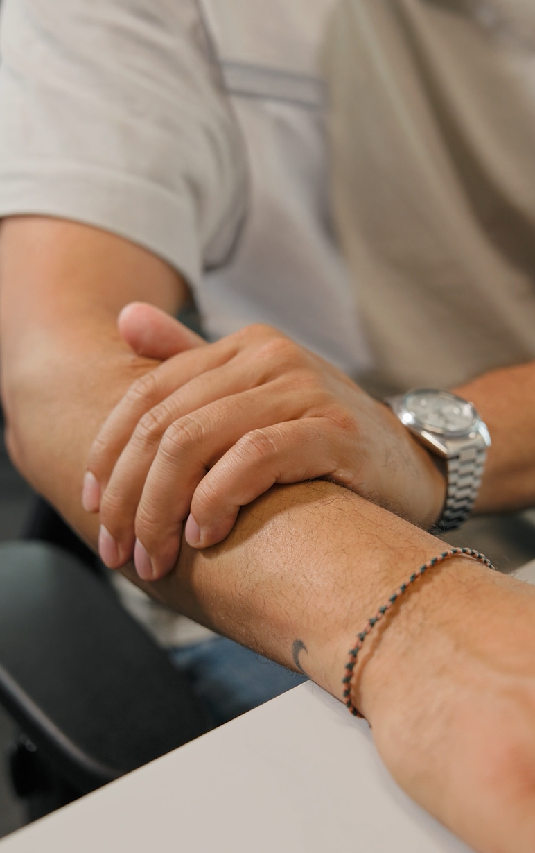 Hand berührt Arm, Symbol für hohe Luftfeuchtigkeit mit Tropfen-Icon.